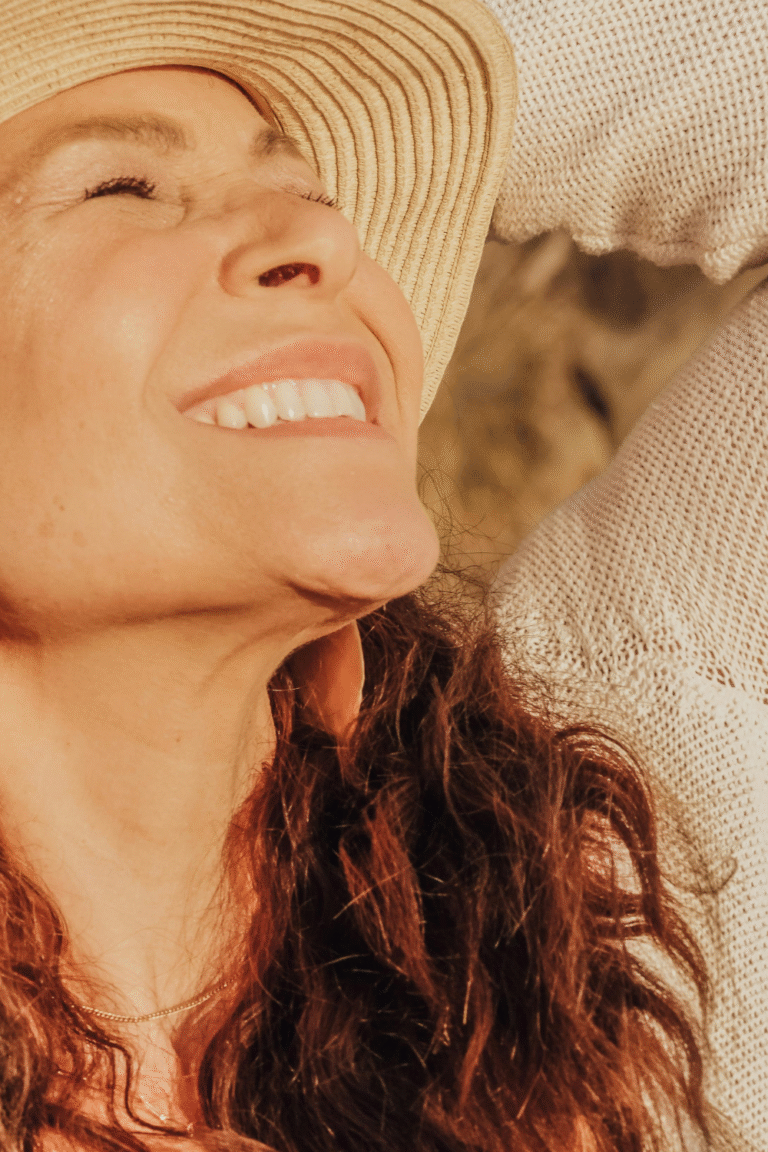 Confident woman smiling with strength and ease, representing courage, clarity, and empowerment from overcoming self-doubt